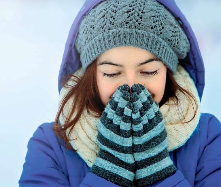 Woman is warming her nose and sinuses.