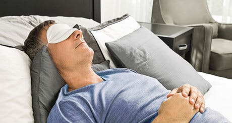 Man sleeping with a sleep mask on Man sleeping with a sleep mask on