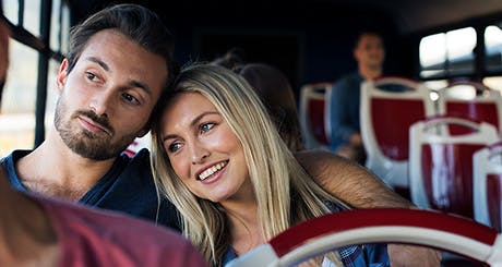 Young couple traveling together on a bus. Young couple traveling together on a bus.