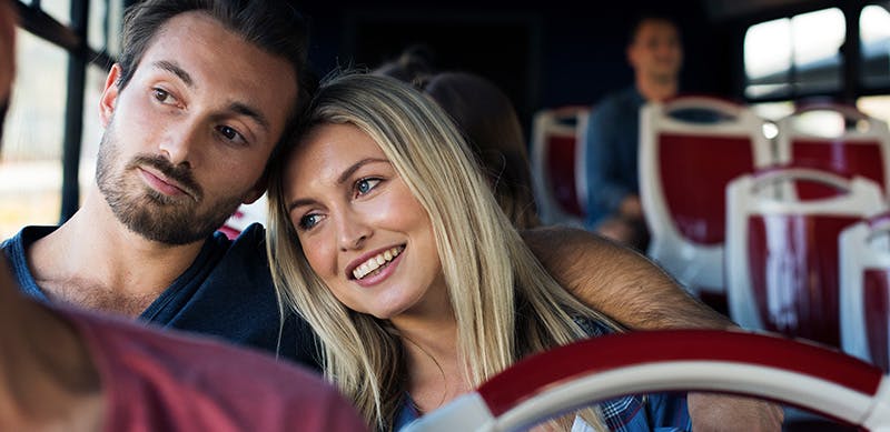 Young couple travelling together on a bus. Young couple travelling together on a bus.