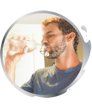 man drinking a glass of iced water man drinking a glass of iced water