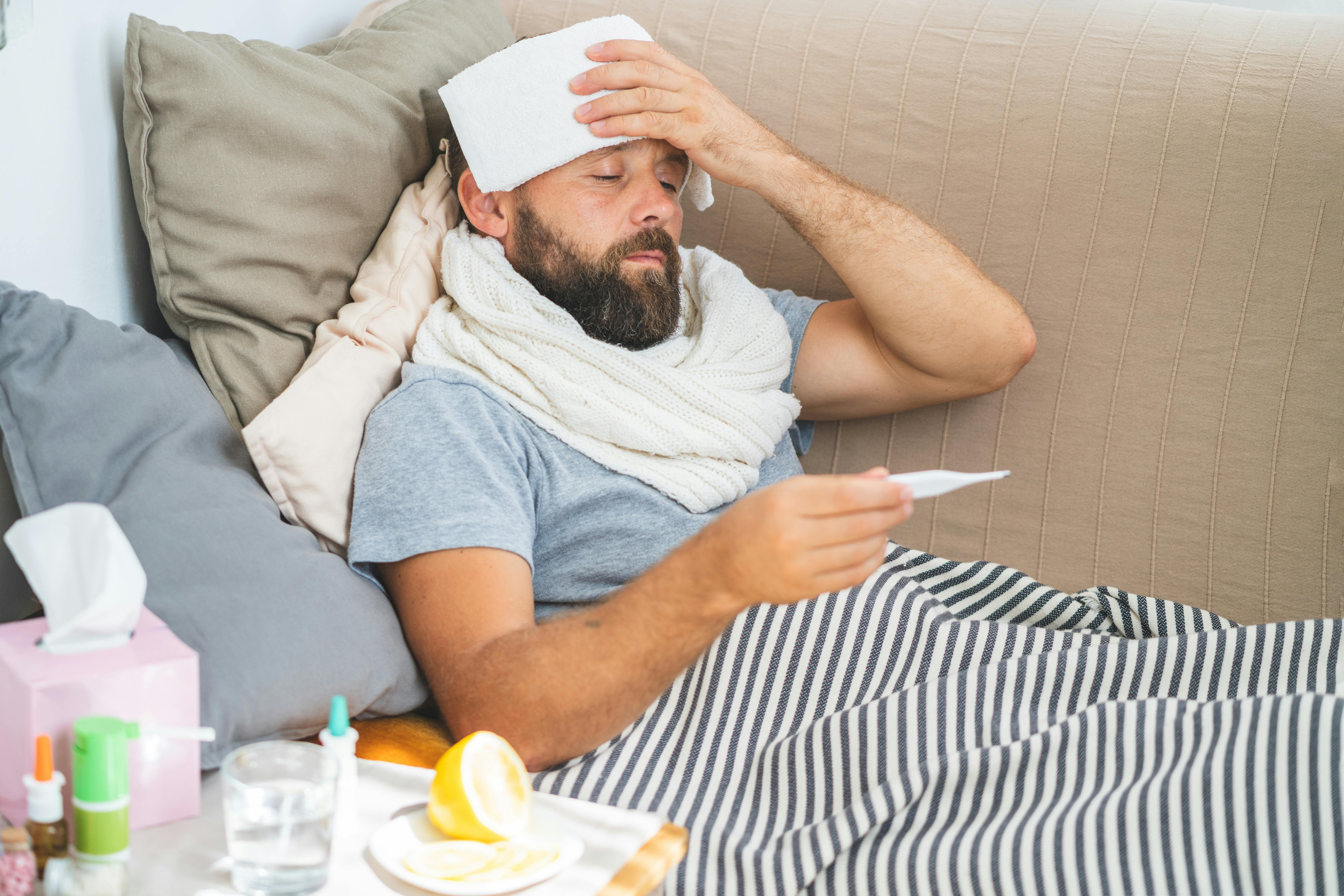 Sick man checks temperature