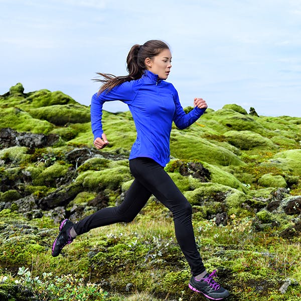 Woman running on a mountain.