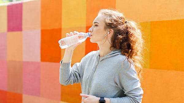 Young woman drinking bottle of water Young woman drinking bottle of water