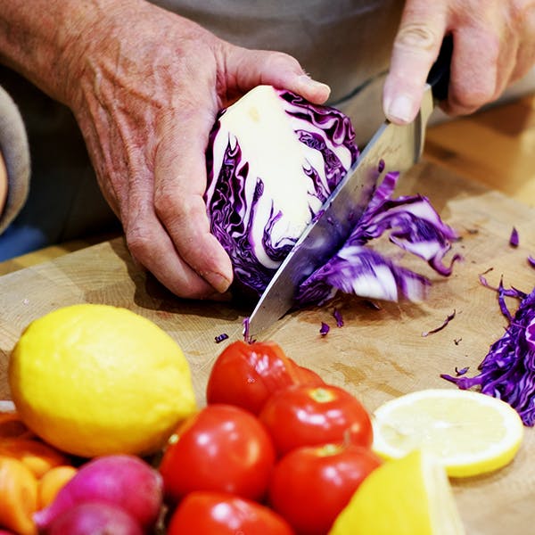Man cutting purple cabbage Man cutting purple cabbage