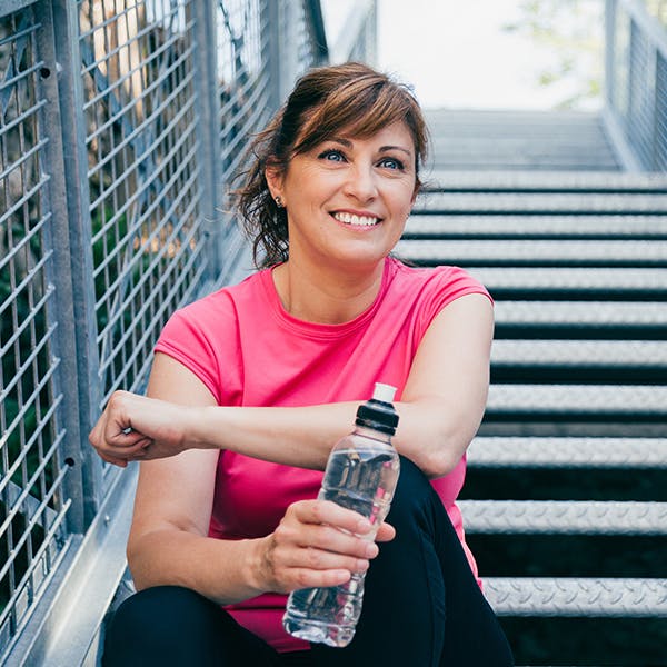 Smiling woman sitting on a stairway outside Smiling woman sitting on a stairway outside