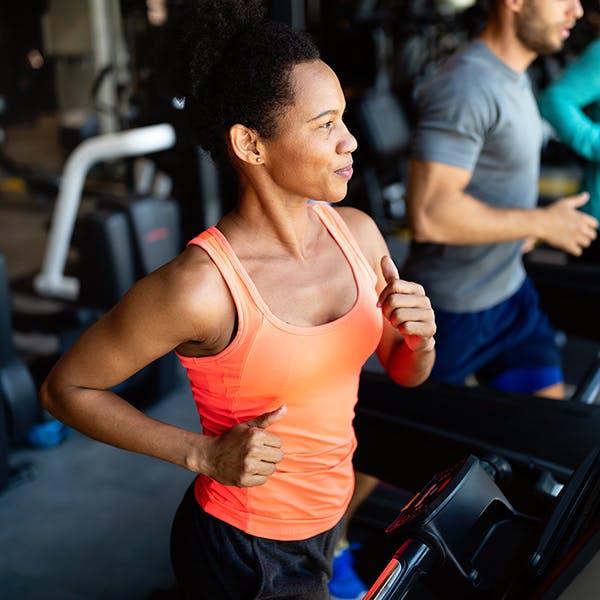 Woman running on a treadmill in an exercise class Woman running on a treadmill in an exercise class