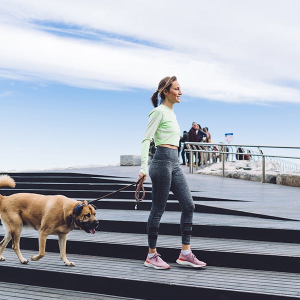 Woman walking her dog outside Woman walking her dog outside