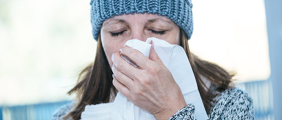 Woman blowing nose
