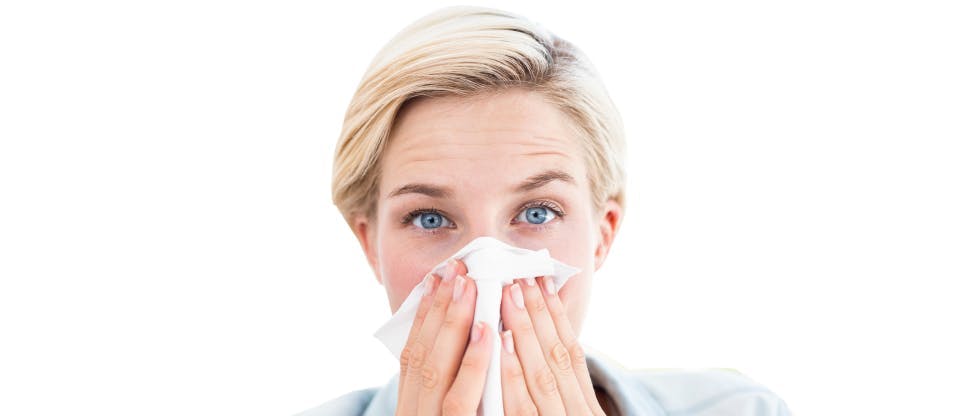 Woman blowing her nose