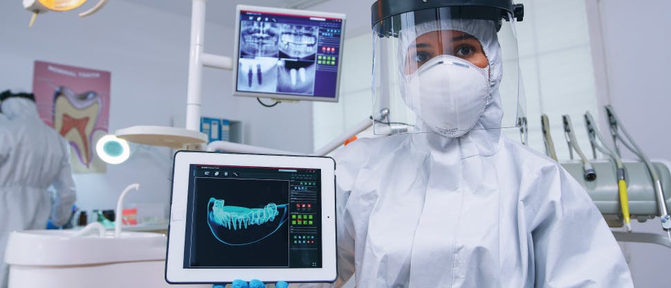 Denrist showing a patient the x-ray of your teeth and pointing out dentin