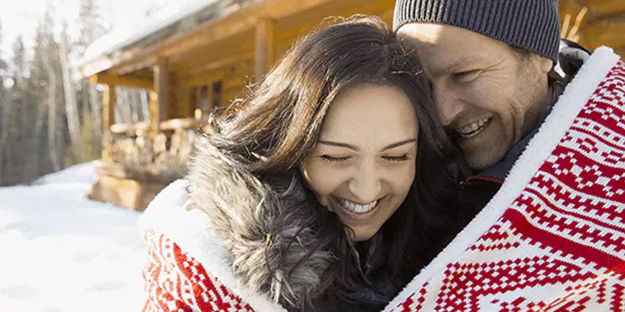 Couple sharing a warm blanket