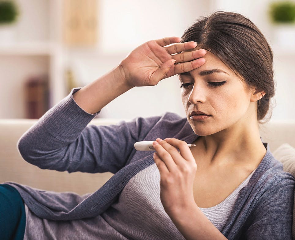 A woman suffering from an intense fever A woman suffering from an intense fever