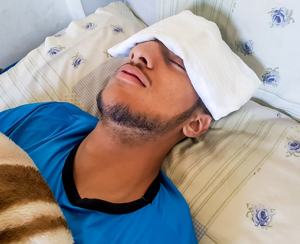 A man trying to reduce his fever A man trying to reduce his fever