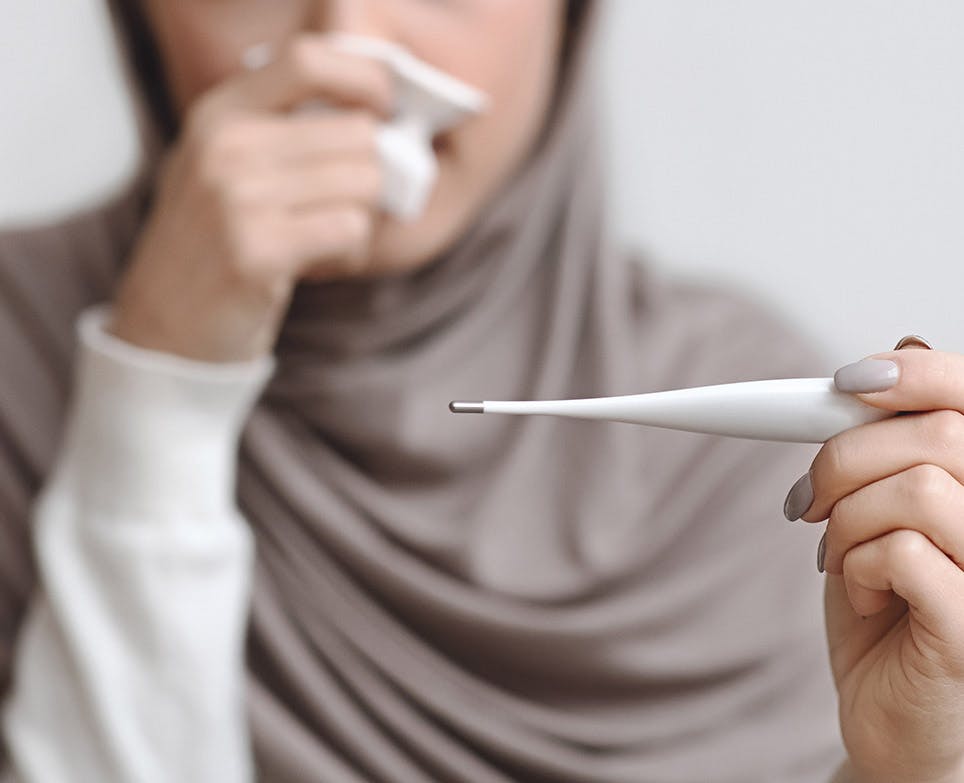 A woman suffering from an intense fever A woman suffering from an intense fever