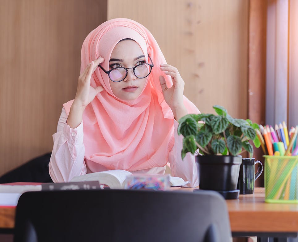 A woman wearing glasses and reading A woman wearing glasses and reading