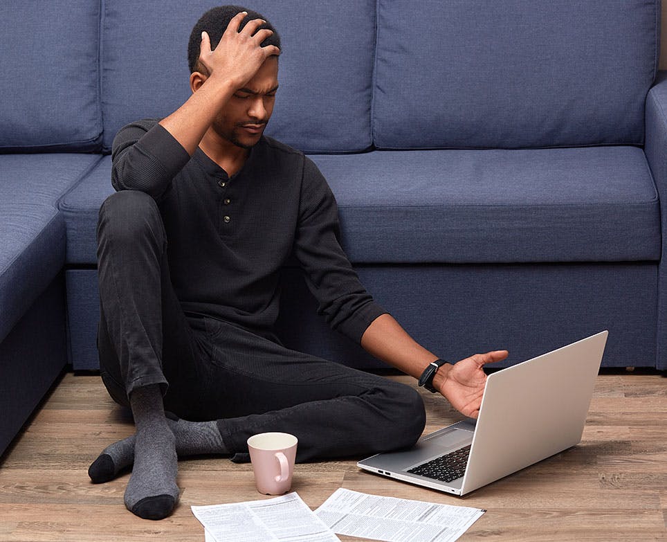 A man suffering from cluster headache while working on his computer A man suffering from cluster headache while working on his computer