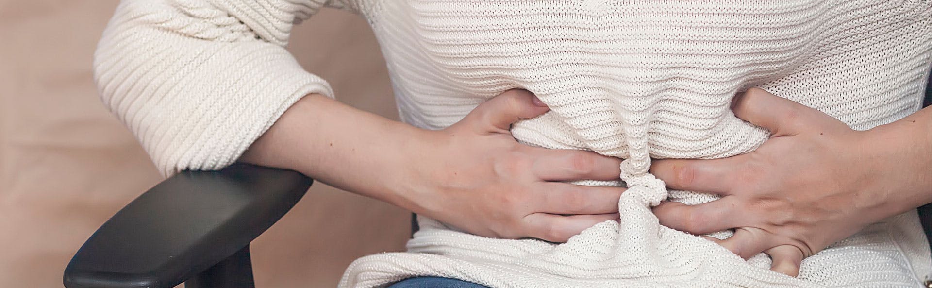 A woman dealing with menstrual cramps A woman dealing with menstrual cramps