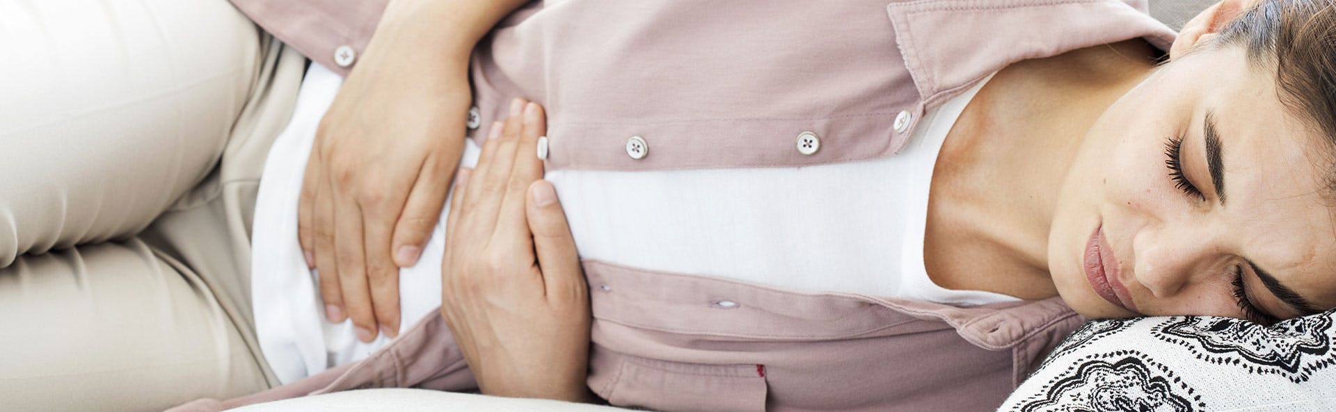 A woman dealing with menstrual cramps A woman dealing with menstrual cramps