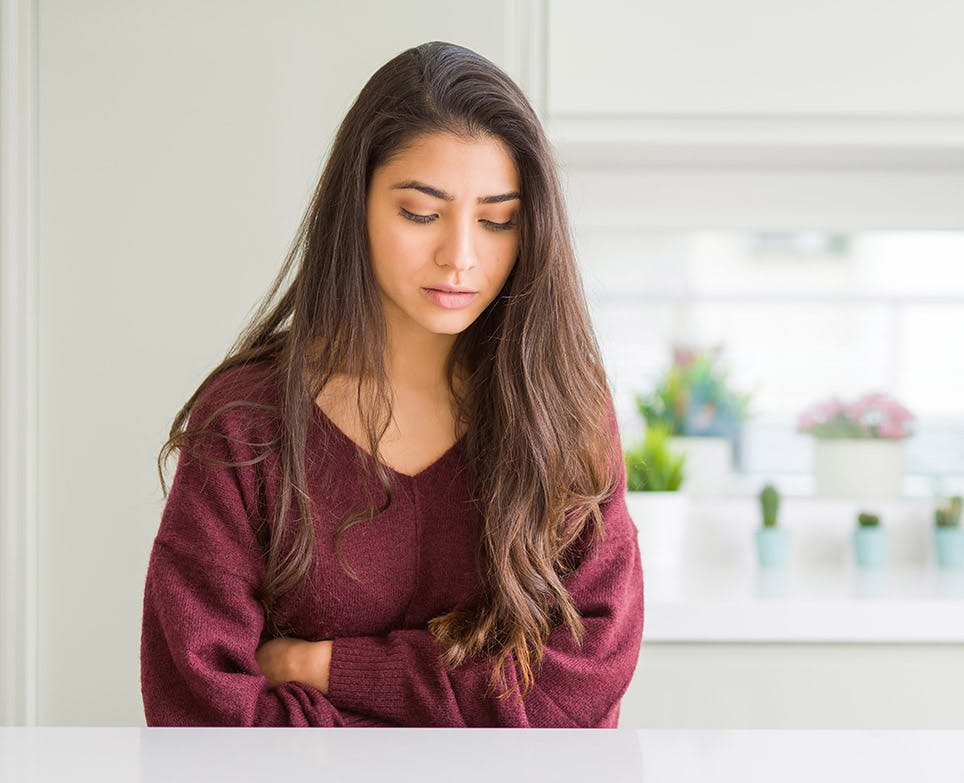A woman dealing with period pain A woman dealing with period pain