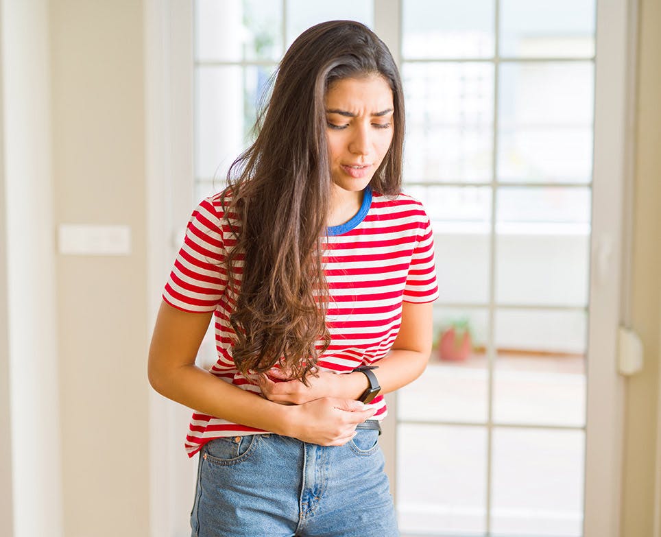 A woman suffering from abdominal pain during her menstruation A woman suffering from abdominal pain during her menstruation