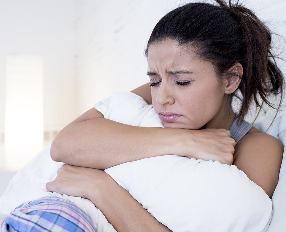 A woman dealing with mentrual pain A woman dealing with mentrual pain