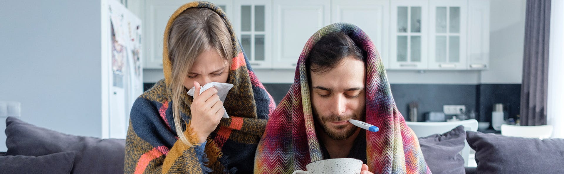 A couple with flu symptoms and fever. A couple with flu symptoms and fever.