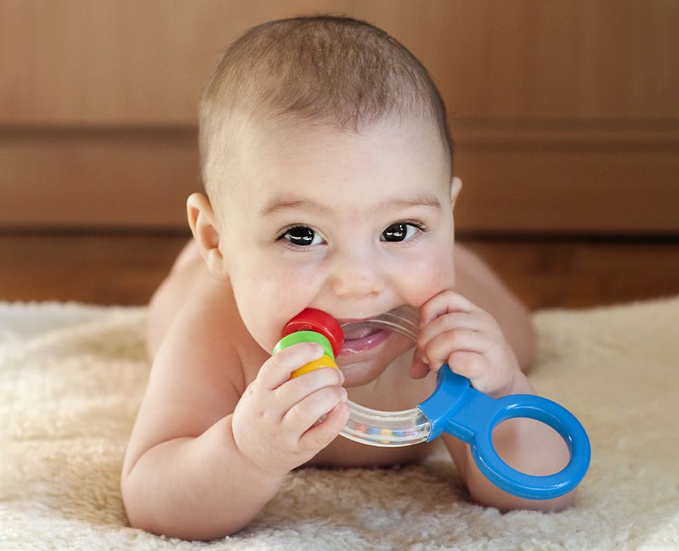 Baby biting a toy for teething. Baby biting a toy for teething.