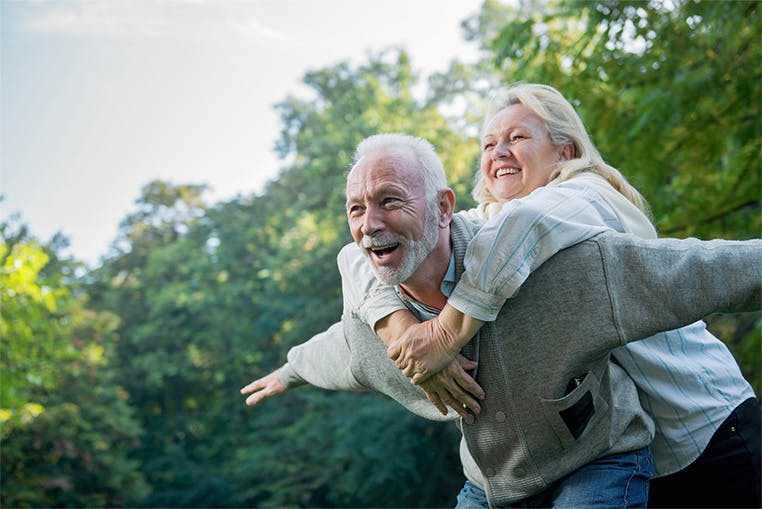 Elderly couple piggy backing Elderly couple piggy backing