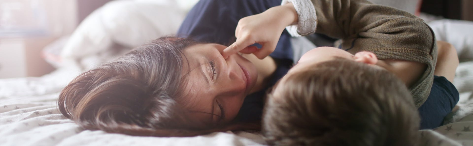 Mum and child cuddling in bed