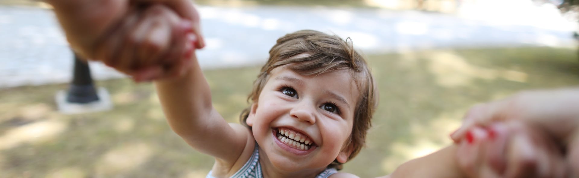 Kid grinning being spun around