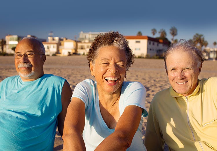 Three Older People Relax On The Beach Three Older People Relax On The Beach