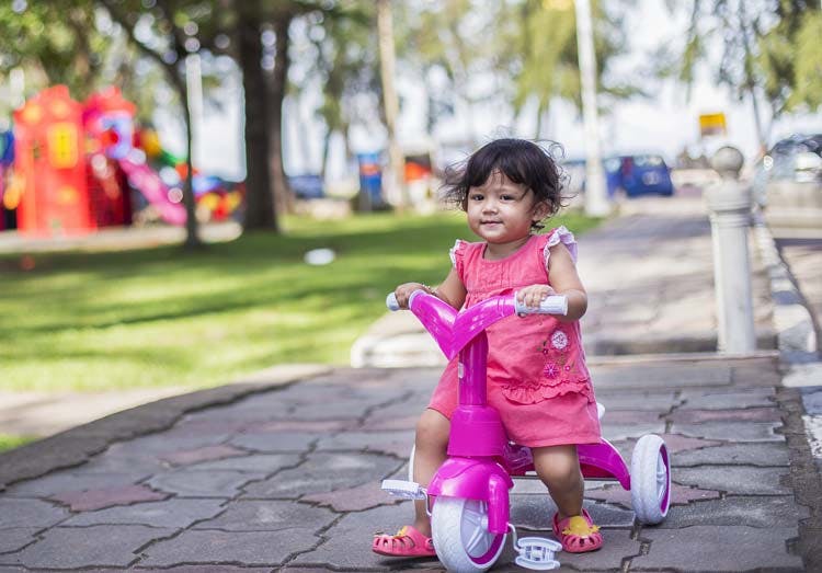 Little girl riding tricycle Little girl riding tricycle