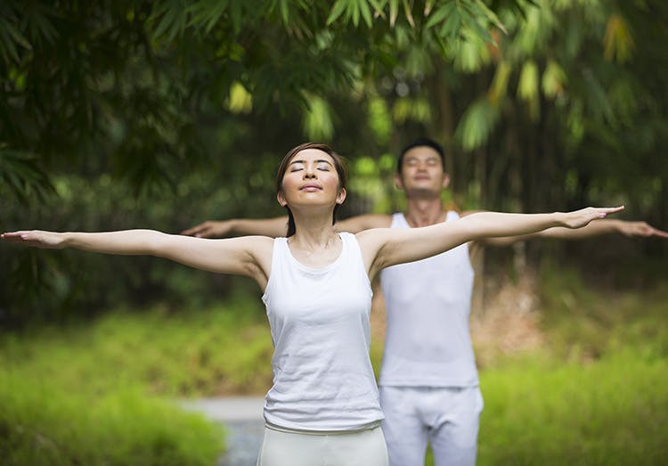 Young couple In warrior poses at the park Young couple In warrior poses at the park