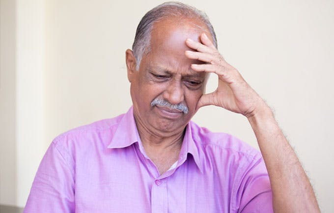 Man experiencing headache Man experiencing headache