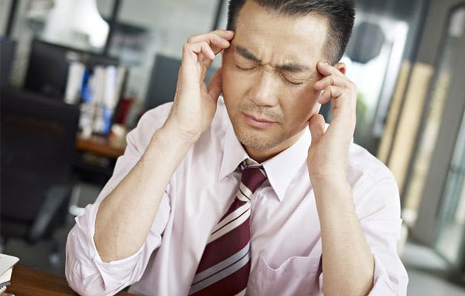 Office worker experiencing headache Office worker experiencing headache