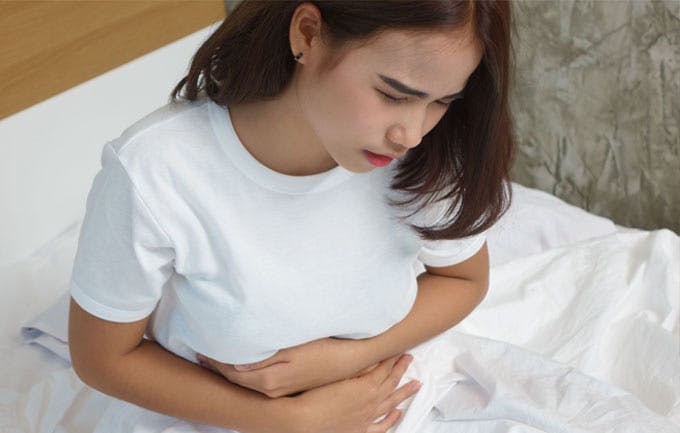 Woman experiencing abdominal pain Woman experiencing abdominal pain