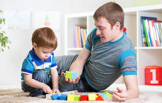 Pai brinca com o seu filho em casa