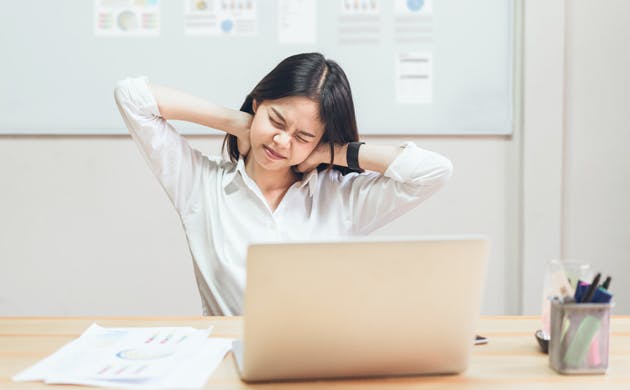 Woman in office with neck ache Woman in office with neck ache