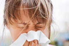 Woman sneezing Woman sneezing