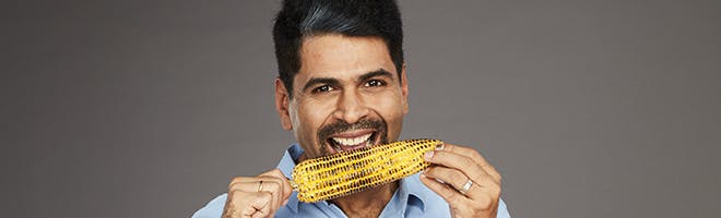 How does denture adhesive make eating more comfortable header image man enjoying difficult to eat food