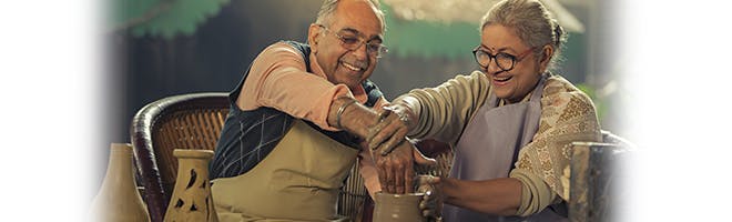 Living comfortably with dentures header image woman eating with husband