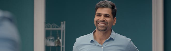 Staying confident with dentures header image Woman and man up close to each other