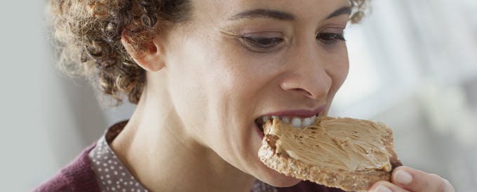 Living with dentures header image Woman eating food