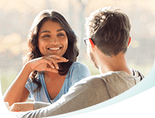 A Woman Smiling at a Man Showing Strong and White Teeth A Woman Smiling at a Man Showing Strong and White Teeth