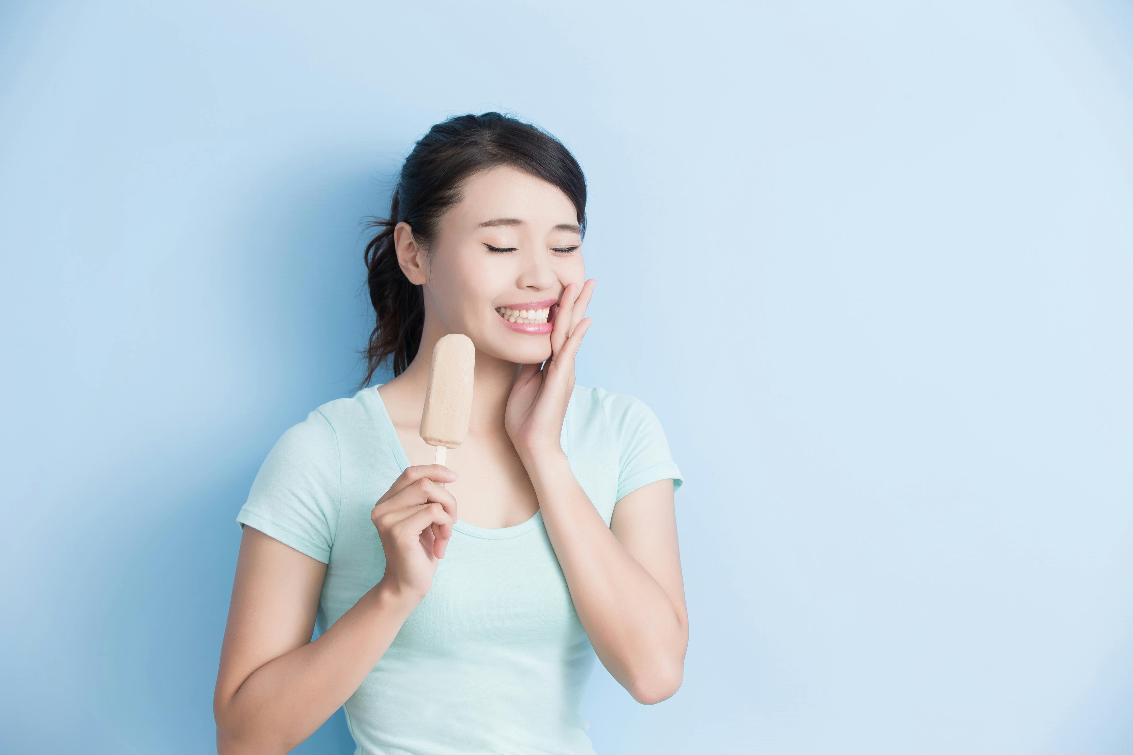 woman in pain after eating cold popsicle woman in pain after eating cold popsicle