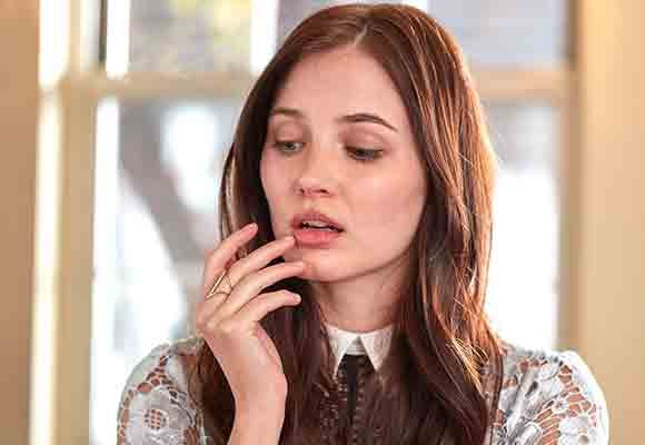 Woman with a cold sore touching her lip. Woman with a cold sore touching her lip.