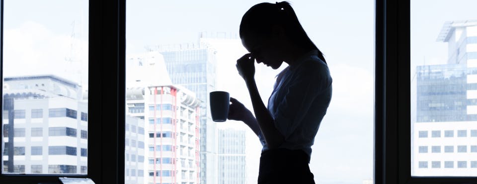 Silhouette of stressed business woman in high-rise building Silhouette of stressed business woman in high-rise building