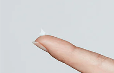 Abreva cream on fingertip for application Abreva cream on fingertip for application