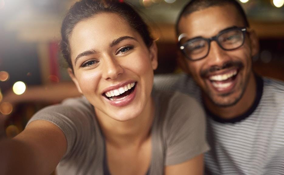man and women smiling widely showing their teeth man and women smiling widely showing their teeth